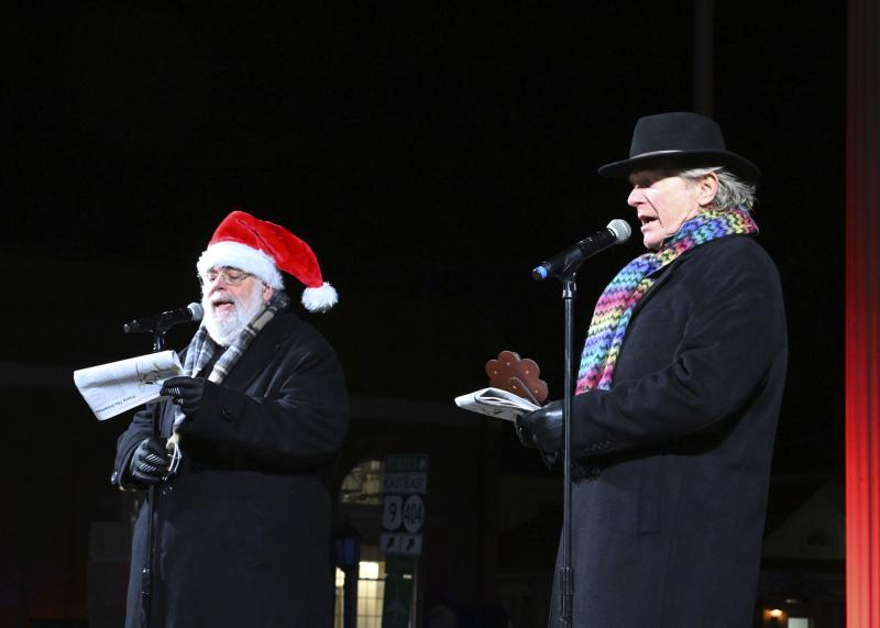 Kevin Short, left, and Ed Shockley entertain the crowd with their musical stylings during the Caroling on The Circle event.
